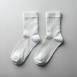 © Ehtisham - A pair of crisp white socks laid flat against a clean. white backdrop.