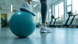 © Emilio - Female physiotherapist with fitball in clinic for physical therapy, support, mobility exercise demonstration. Fitness, health worker for help, stretching of legs and moving of joints or rehabilitation