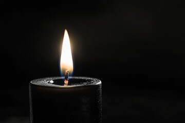 Canvas Print - Single candle flame in dark