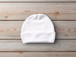 © J-Gen - White baby hat mockup. Baby knitted bobble hat or beanie hat newborn clothing mock up on wooden background.