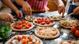 Kids making their own mini pizzas with a variety of toppings