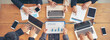 © prachid - Group of People working together with laptop on wooden office desk.Professional business team meeting,discussion and research together start up project strategy.Group of conlleague plan to work online