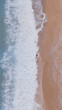 © Yakov Knyazev/Stocksy - Aerial View of Person in Ocean Waves on Sandy Beach