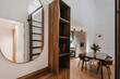 © Nibuya Qubik/Stocksy - A modern, compact kitchen and dining area with wooden furniture