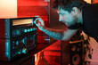 © Luciano Spinelli/Stocksy - Man at night selecting song to play on the radio with cozy soft light