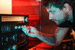© Luciano Spinelli/Stocksy - Portrait of dj selecting a radio frequency and looking attentive