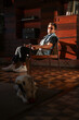 © Luciano Spinelli/Stocksy - Portrait of artist and his dog in rooftop apartment during sunset
