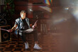 © Luciano Spinelli/Stocksy - Rocker man sitting in his fancy apartment select a record to listen