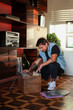 © Luciano Spinelli/Stocksy - Portrait dj selecting the next disc he will play in living room