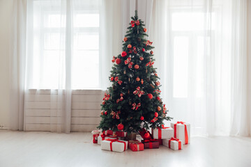 Christmas tree with gifts for the new year house with window interior