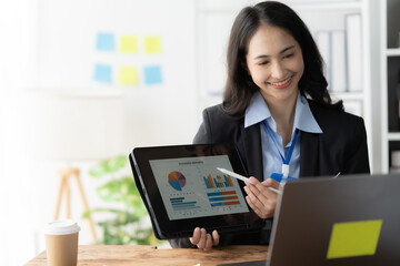 Confident Presentation:  A smiling businesswoman confidently presents data on a digital tablet during a virtual meeting. This professional image evokes confidence, clarity, and the power of technology