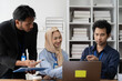 © Kritdanai - Collaborative Synergy: A diverse team of professionals engage in focused discussion, leveraging their unique strengths to achieve shared goals in a modern office setting.