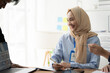 © Kritdanai - Businesswoman in Hijab: A confident and professional woman in a hijab, actively participates in a business meeting, demonstrating inclusivity and diversity in the workplace.