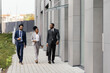© Oleksii Syrotkin/Stocksy - Office manager walking outdoors with her colleagues