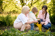 © Iuliia Versta/Stocksy - family plants beds in the garden