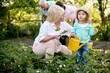 © Iuliia Versta/Stocksy - granny with her little granddaughter watered a plants