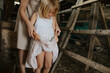 © Anna Artemenko/Stocksy - woman with little daughter collecting eggs in a chicken coop