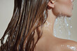 © Boadicea - Young woman taking shower and washing her long hair