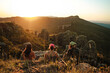 © Luis Herrera/Stocksy - travel Friends Resting at Sunset on the Mountain