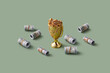 © Yaroslav Danylchenko/Stocksy - Bundles of dollar bills laying around golden cup with jewels