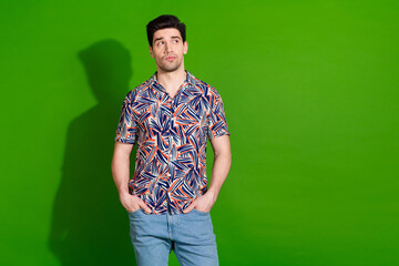 Wall Mural - Photo of smart cool guy with bristle stylish haircut dressed print shirt look at sale empty space isolated on green color background