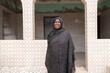 © Alvaro Lavin/Stocksy - Senegalese woman smiling and posing in a building in africa