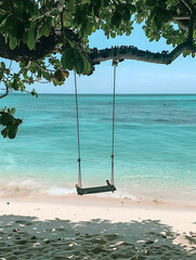 A view of the beach with clear turquoise water and white sand, there is an old wooden swing hanging from one tree branch, on it lies two people who can be seen in profile, behind them you see another 