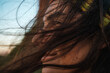 © Luis Herrera/Stocksy - profile of woman with long hair blowing with the wind