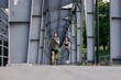© Oleksii Syrotkin/Stocksy - Fitness couple speeding up while running together in stadium path