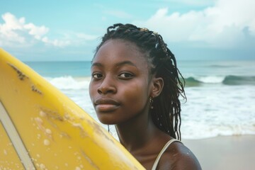 Portrait of a young African American female surfer on the beach