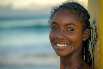 Portrait of a young African American female surfer on the beach