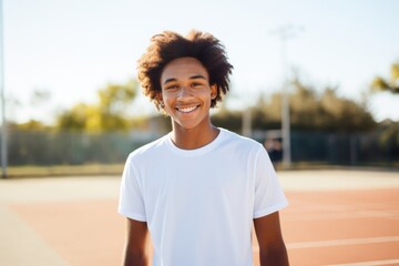 Poster - Smiling portrait of African American male teenager on tennis court