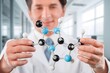 © BillionPhotos.com - Scientist holding molecular model in laboratory