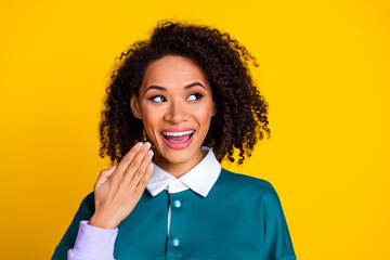 Wall Mural - Photo of ecstatic woman with perming coiffure dressed stylish shirt look at proposition empty space isolated on yellow color background