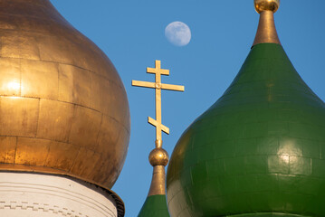 The domes of the church in close-up on a full moon in a blue sky