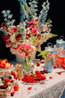© Maria Sher/Stocksy - Elegant Floral Table Setting with Berries And Sweets