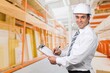 © BillionPhotos.com - A confident engineer stands wearing a safety helmet