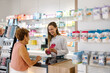 © VICTOR TORRES/Stocksy - Pharmacy interaction between pharmacist and customer in retail setting