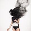 © Ulas&Merve/Stocksy - Fashion Model Posing with White Handbag and Flowing Fabric