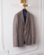 © Elena Kharichkina/Stocksy - Brown Plaid Blazer on Hanger