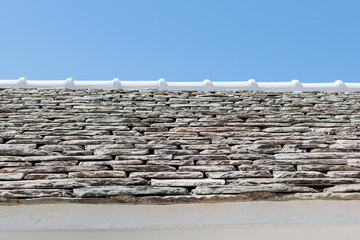 tone wall under a clear blue sky in a sunny setting