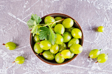 Wall Mural - fresh organic gooseberries in a wooden bowl