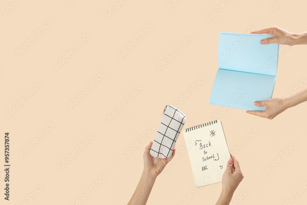 Female hands holding pencil case and notebooks with text BACK TO SCHOOL on beige background