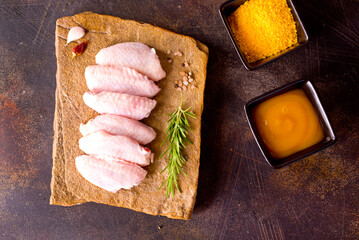 Canvas Print - Raw chicken wings with ingredients for cooking