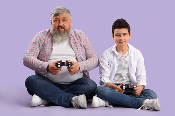 Poster - Happy grandfather with his cute grandson playing video games on purple background