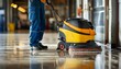 © jechm - Industrial floor cleaning machine in use by worker in a clean facility