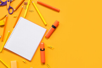 Wall Mural - Blank notebook with different stationery supplies on orange background