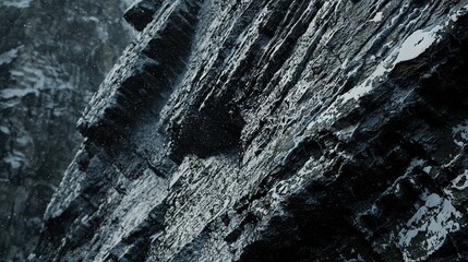 Sticker -   A close-up of a snow-covered rock face with a snowy mountain in the background and trees surrounding it