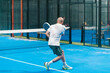 © Ezequiel Giménez/Stocksy - Male Padel Player Returning Ball