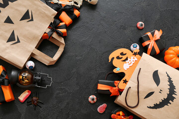 Sticker - Composition with paper shopping bags, gifts and decorations for Halloween on dark background